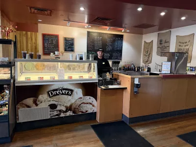 Worker standing behind the counter at Prospector's Perk.