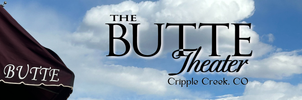 Blue sky with clouds with maroon awning stating Butte